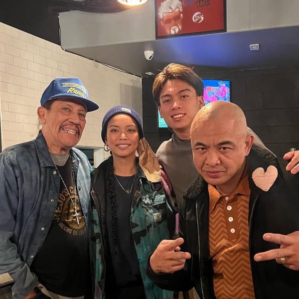 Danny Trejo and three other people smiling for a photo inside The Park's Finest.