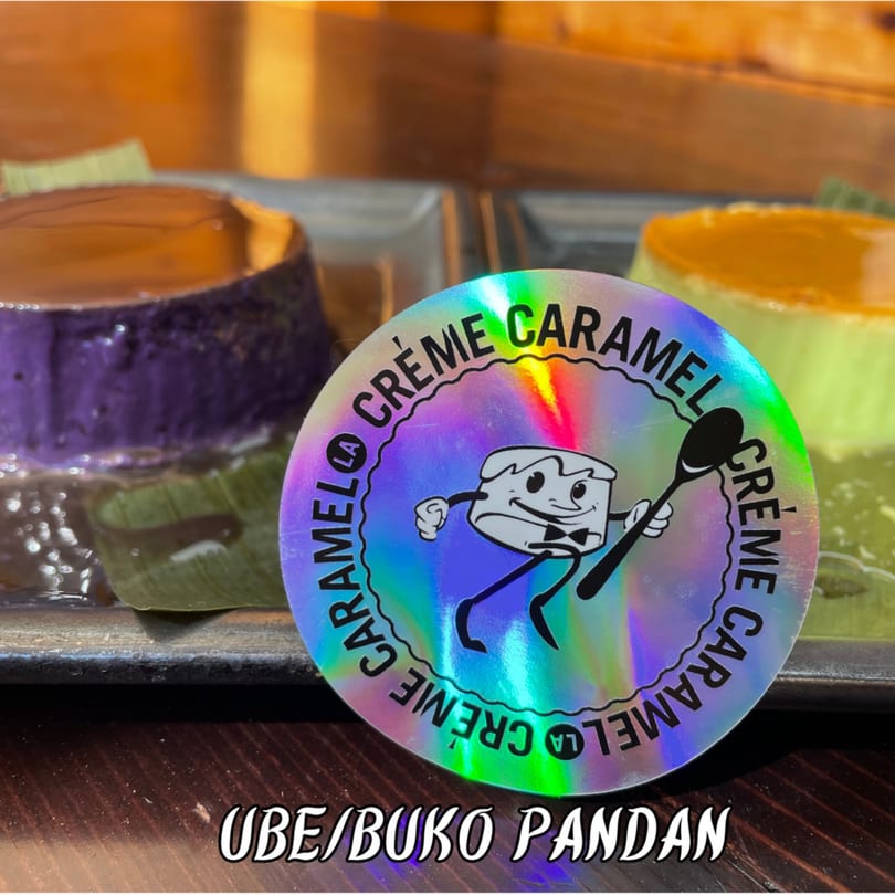 Ube and buko pandan crème caramels with a holographic La Crème Caramel sticker in the foreground.